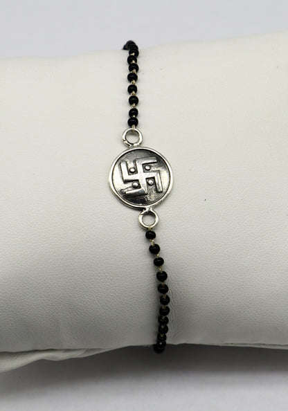 Sterling silver 8.5-inch black beaded Swastik bracelet by TRIBAL ORNAMENTS with customized design, featuring traditional beadwork.