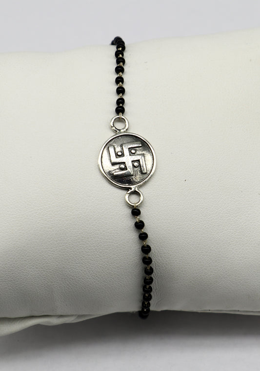 Sterling silver 8.5-inch black beaded Swastik bracelet by TRIBAL ORNAMENTS with customized design, featuring traditional beadwork.