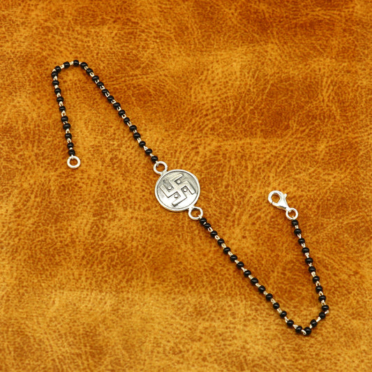 Sterling silver 8.5-inch black beaded Swastik bracelet with customized design by TRIBAL ORNAMENTS.