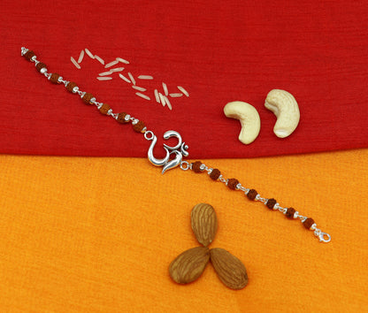 Sterling silver OM Rudraksha beaded bracelet with Aum charm from TRIBAL ORNAMENTS, showcasing intricate bead details and craftsmanship.