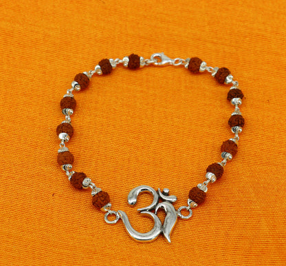 925 Sterling Silver OM Rudraksha beaded bracelet with Aum symbol, featuring custom beaded design and intricate craftsmanship.