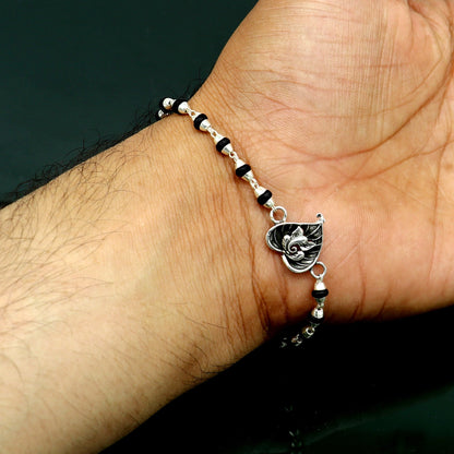 925 sterling silver Ganesha design tulsi beaded bracelet with intricate details, ideal for special occasions or spiritual wear.