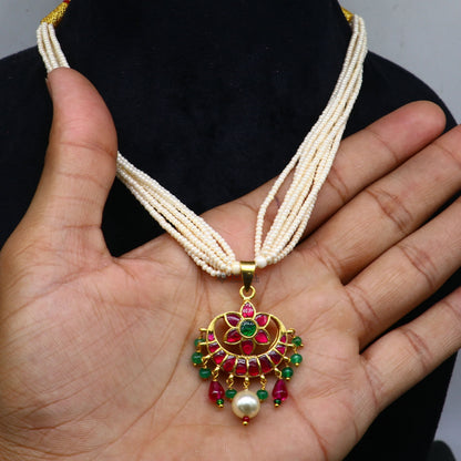 Sterling silver jewelry set with green and red kundan work pendant, trendy necklace with multiline pearl strands by TRIBAL ORNAMENTS.