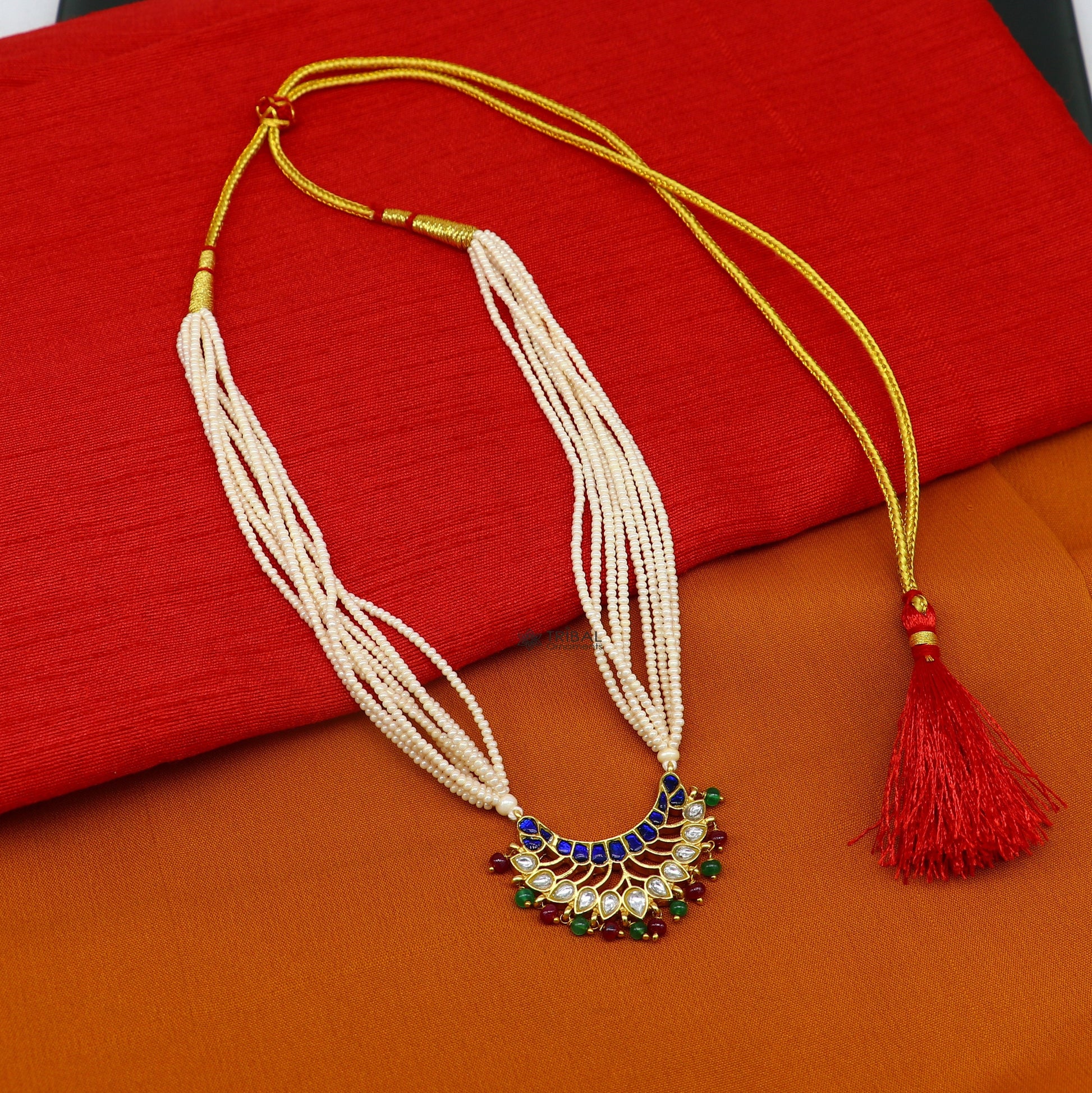 Sterling silver India traditional kundan work pendant with peacock design, paired with multiline pearl necklace in jewelry set.
