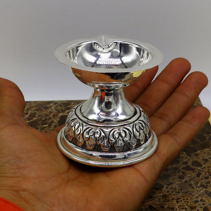 Sterling silver oil lamp with chitai and kandrai work, traditional deepak temple article, detailed puja utensil art figurine.