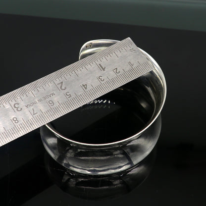 Sterling silver cuff bracelet with a unique curved design, shiny and elegant, by Tribal Ornaments.