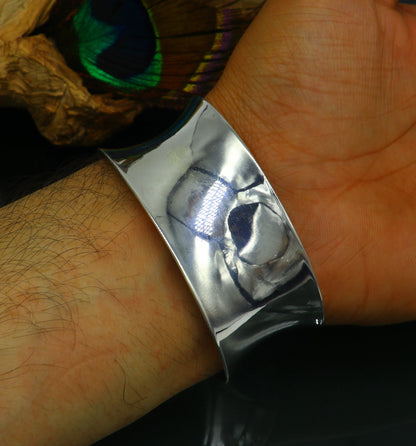 Sterling silver cuff bracelet with a unique curved design, shiny and elegant, by TRIBAL ORNAMENTS.