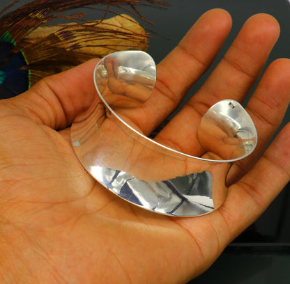 Sterling silver cuff bracelet with a unique curved design, shiny finish, elegant trendy jewelry by TRIBAL ORNAMENTS.