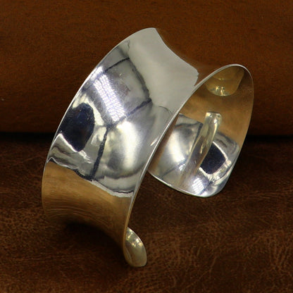 Sterling silver cuff bracelet with a unique curved design, shiny and elegant, by TRIBAL ORNAMENTS.