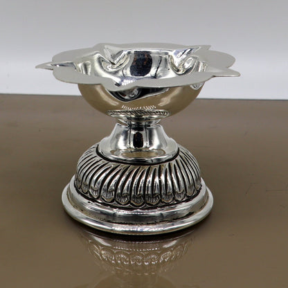 Sterling silver oil lamp with chitai and kandrai work, traditional silver Deepak for puja and temple decor, detailed craftsmanship.
