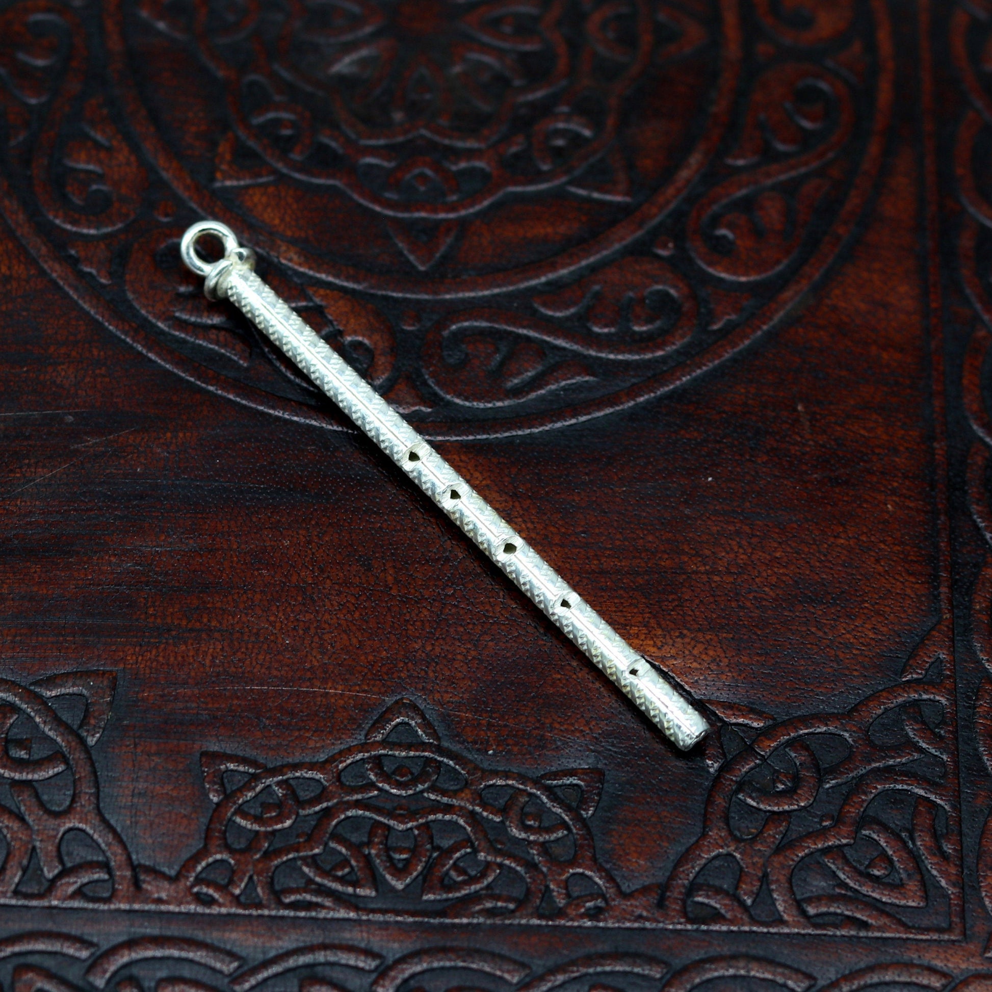 Handmade sterling silver Krishna idol with flute, featuring detailed craftsmanship, perfect for gifting or religious decor.