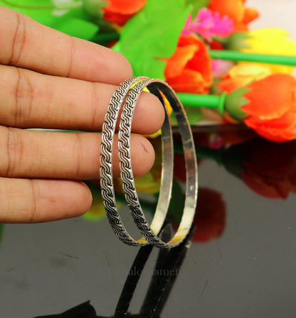 Sterling silver customized designer bangle bracelet with intricate tribal-inspired work, perfect for gifting or brides.