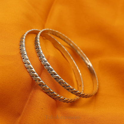 Sterling silver custom-designed bangle bracelet with intricate tribal patterns, stylish jewelry for brides and special gifting.