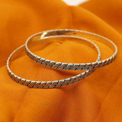 Sterling silver custom-designed bangle bracelet with intricate tribal patterns, stylish jewelry perfect for gifting or bridesmaids.