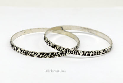Sterling silver customized bangle bracelet with intricate tribal design, stylish jewelry perfect for gifting or bridesmaids.
