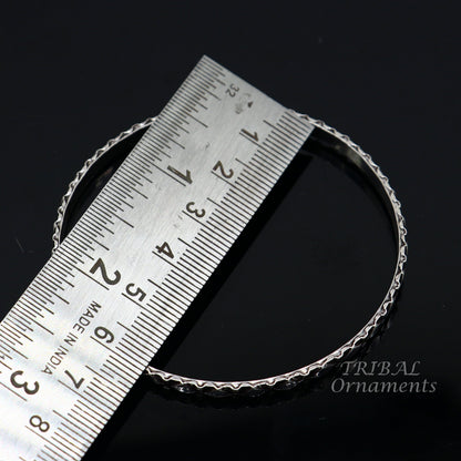 Sterling silver designer bangle bracelet by TRIBAL ORNAMENTS featuring custom work and intricate patterns, perfect for gifting or bridal jewelry.