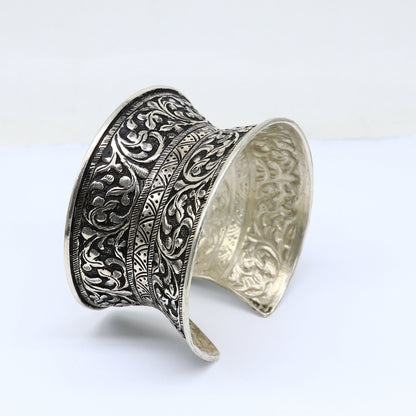 Sterling silver tribal cuff bracelet with adjustable fit, ethnic boho design, ideal for weddings and Navratri jewelry.