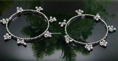 Sterling silver charm bangle bracelet with intricate tribal design, oxidized finish, personalized jewelry for belly dance performance.