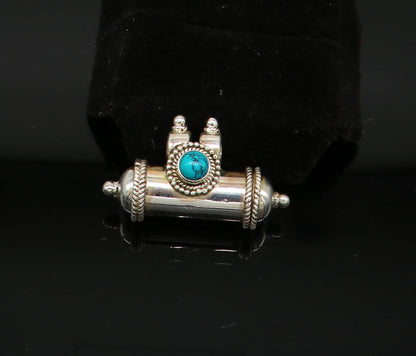 925 sterling silver amulet pendant with vibrant turquoise stone, featuring tribal-inspired design and intricate detailing.