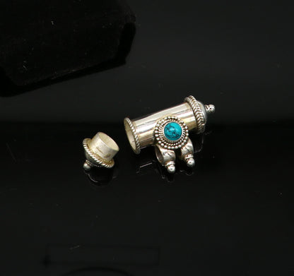 Sterling silver amulet pendant with a vibrant turquoise stone, featuring tribal design and intricate box-shaped craftsmanship.