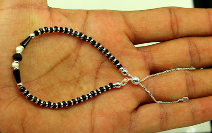 Sterling silver beaded bracelet with black onyx stone and Nazariya charm, adjustable jewelry for girls by TRIBAL ORNAMENTS.