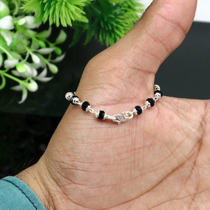 925 sterling silver Nazariya bracelet with black beads, designed for babies, stylish jewelry to protect from evil eyes in India.