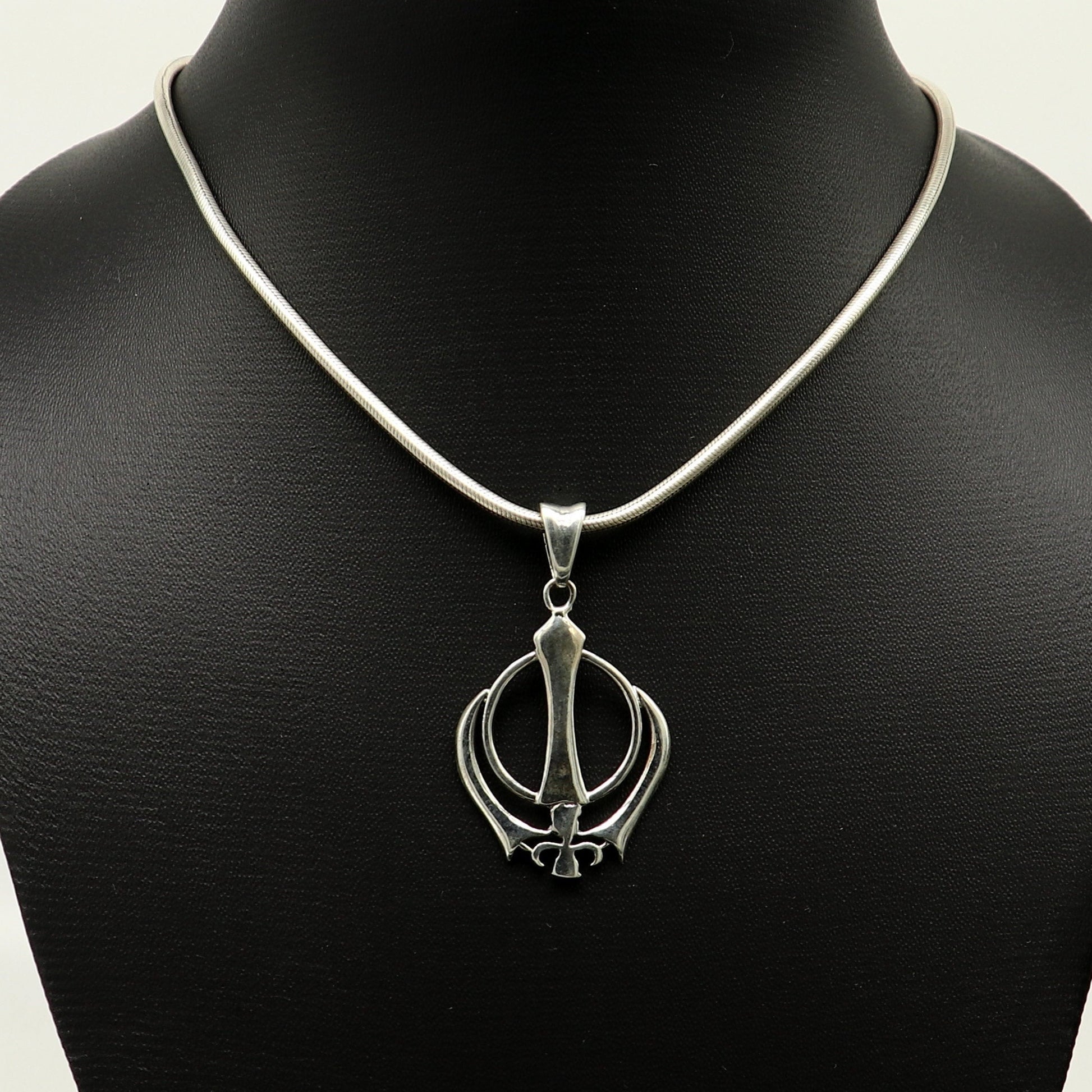 Sterling silver Khalsa Waheguru symbol pendant with customized design, featuring intricate Sikh logo craftsmanship from Tribal Ornaments.
