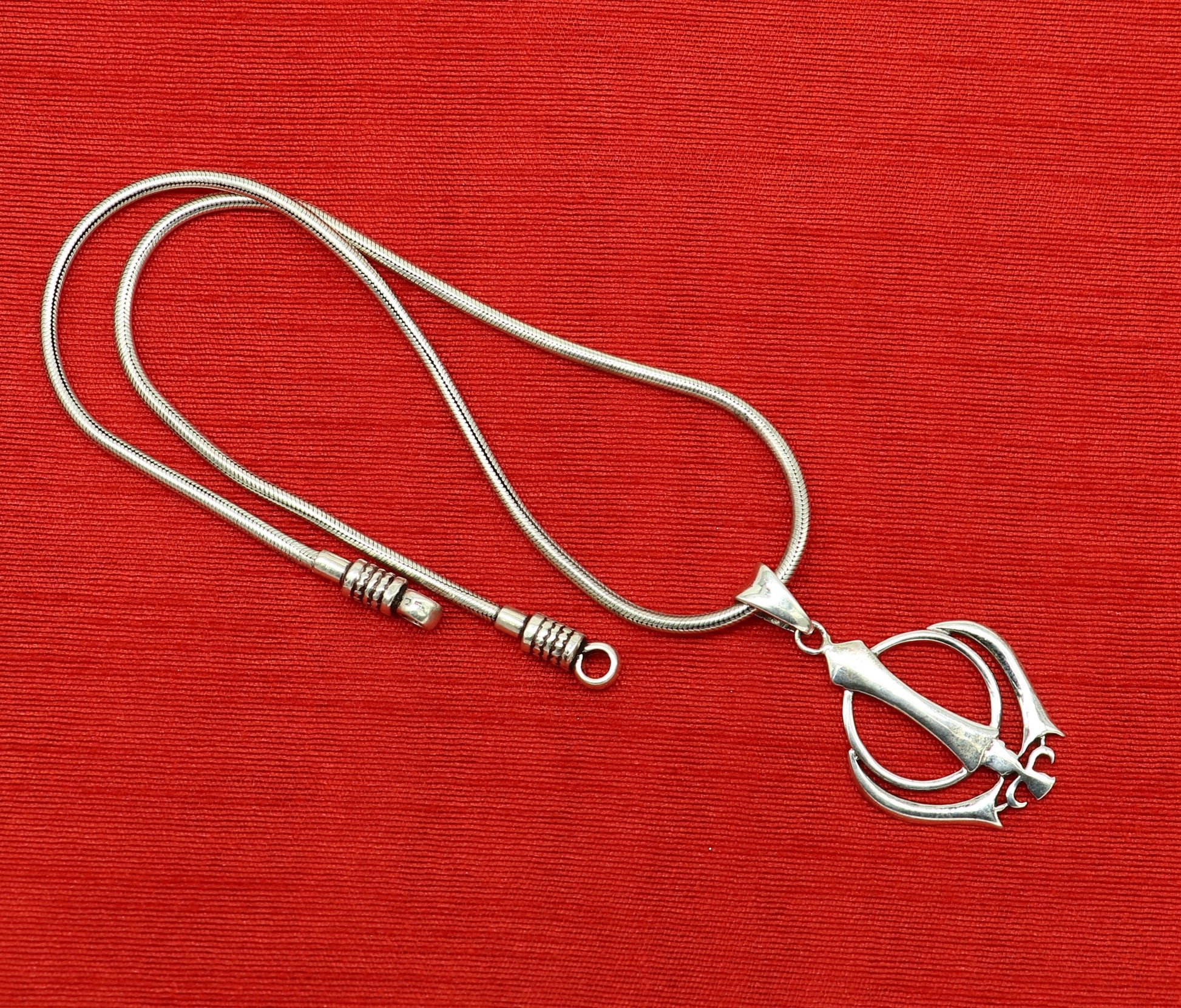925 sterling silver Khalsa Waheguru symbol pendant featuring customized design, ideal for blessing jewelry from TRIBAL ORNAMENTS.