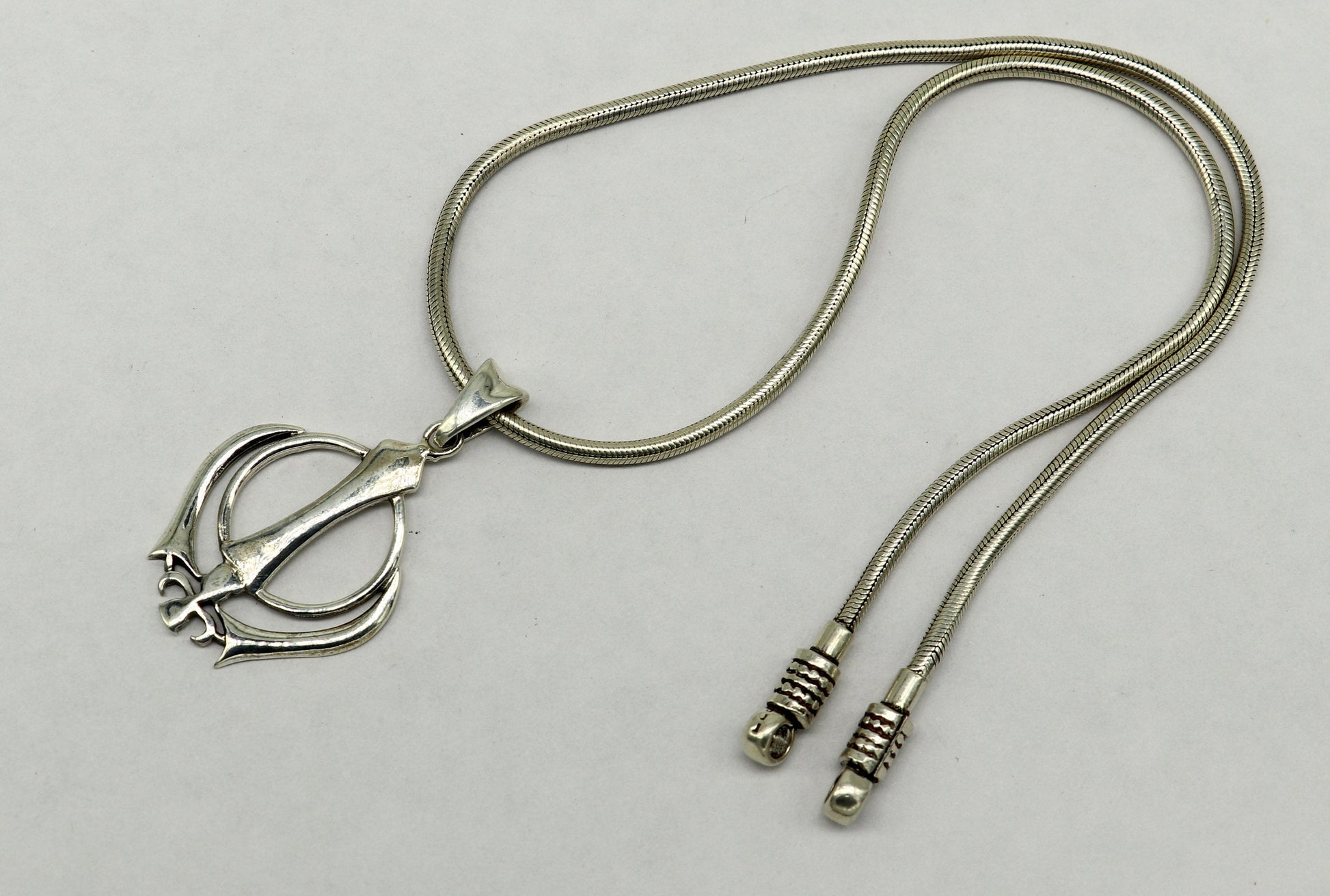 Sterling silver Khalsa Waheguru symbol pendant with customized design, religious blessing jewelry from TRIBAL ORNAMENTS.