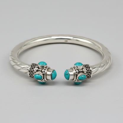 Sterling silver cuff bangle with vibrant blue turquoise stone, handcrafted tribal jewelry by TRIBAL ORNAMENTS, stylish and customizable.