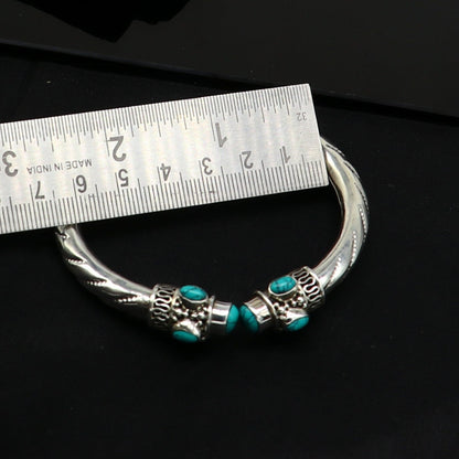 Sterling silver cuff bangle with blue turquoise stone by TRIBAL ORNAMENTS, showcasing a stylish, customizable jewelry design.