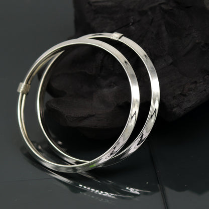 Sterling silver customized bangle bracelet by TRIBAL ORNAMENTS, shiny, stylish, flexible tribal jewelry kada with intricate design.