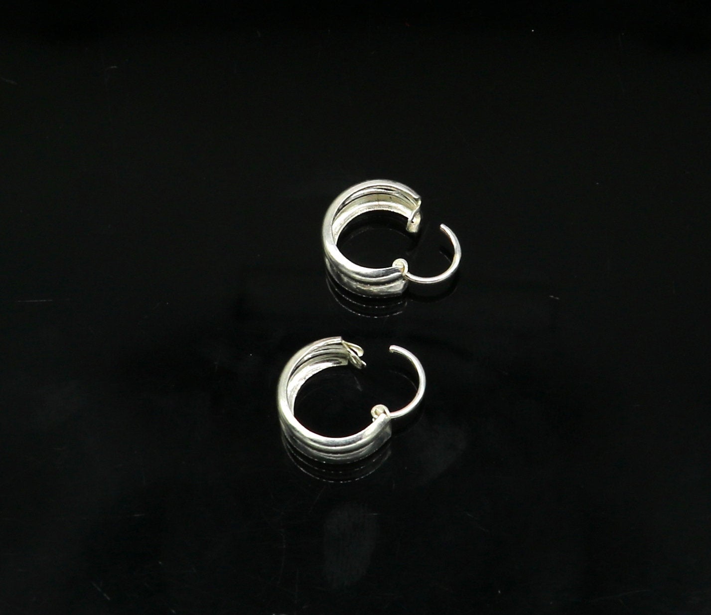 Sterling silver traditional Indian style hoops earring by TRIBAL ORNAMENTS, lightweight unisex design with intricate craftsmanship.