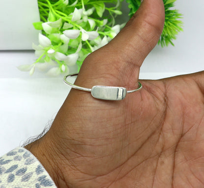 Sterling silver baby bangle from TRIBAL ORNAMENTS with a plain bright design, ideal for newborn baby bracelets or gifts.