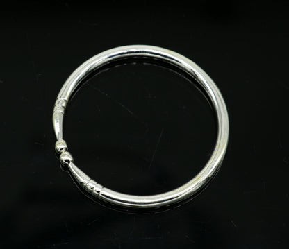 Sterling silver baby bangle bracelet with a bright plain design, adjustable for newborns, by TRIBAL ORNAMENTS.