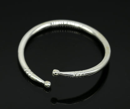 Sterling silver baby bangle bracelet with a plain bright design, adjustable, ideal for newborns, by TRIBAL ORNAMENTS.