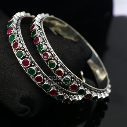 Sterling silver bangle bracelet with vibrant green and red stones, elegant jewelry piece for women and girls by TRIBAL ORNAMENTS.