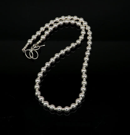 Sterling silver beaded necklace featuring shiny, plain design, modern trendy style, ideal for brides and elegant occasions.