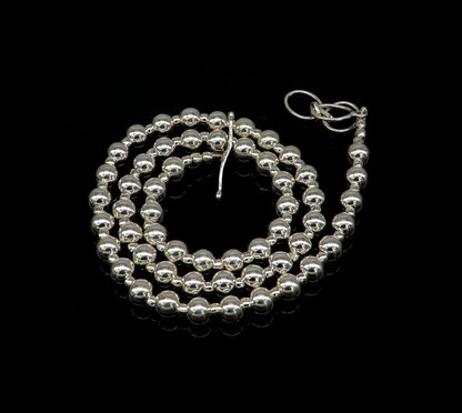 Sterling silver beaded necklace by TRIBAL ORNAMENTS featuring shiny, plain beads, perfect for wedding or trendy stylish jewelry.