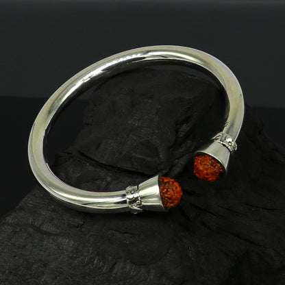 Silver cuff bracelet with shiny Rudraksha beads, unisex design, crafted from 925 sterling silver by TRIBAL ORNAMENTS.