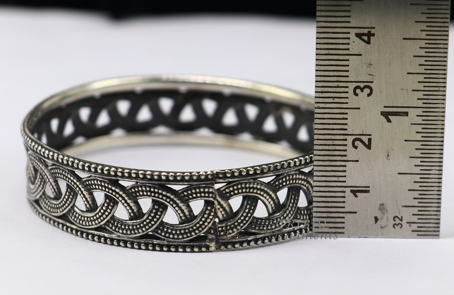 Sterling silver flower design bangle bracelet from TRIBAL ORNAMENTS' wedding jewelry collection, featuring intricate floral details.