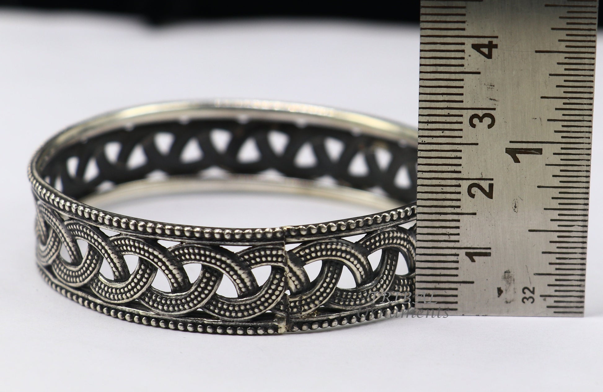 Sterling silver flower design bangle bracelet from TRIBAL ORNAMENTS' wedding jewelry collection, featuring intricate floral details.