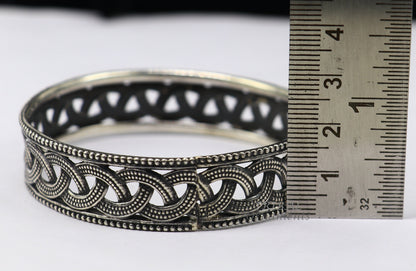 Sterling silver flower design bangle bracelet from TRIBAL ORNAMENTS' wedding jewelry collection, featuring intricate floral details.