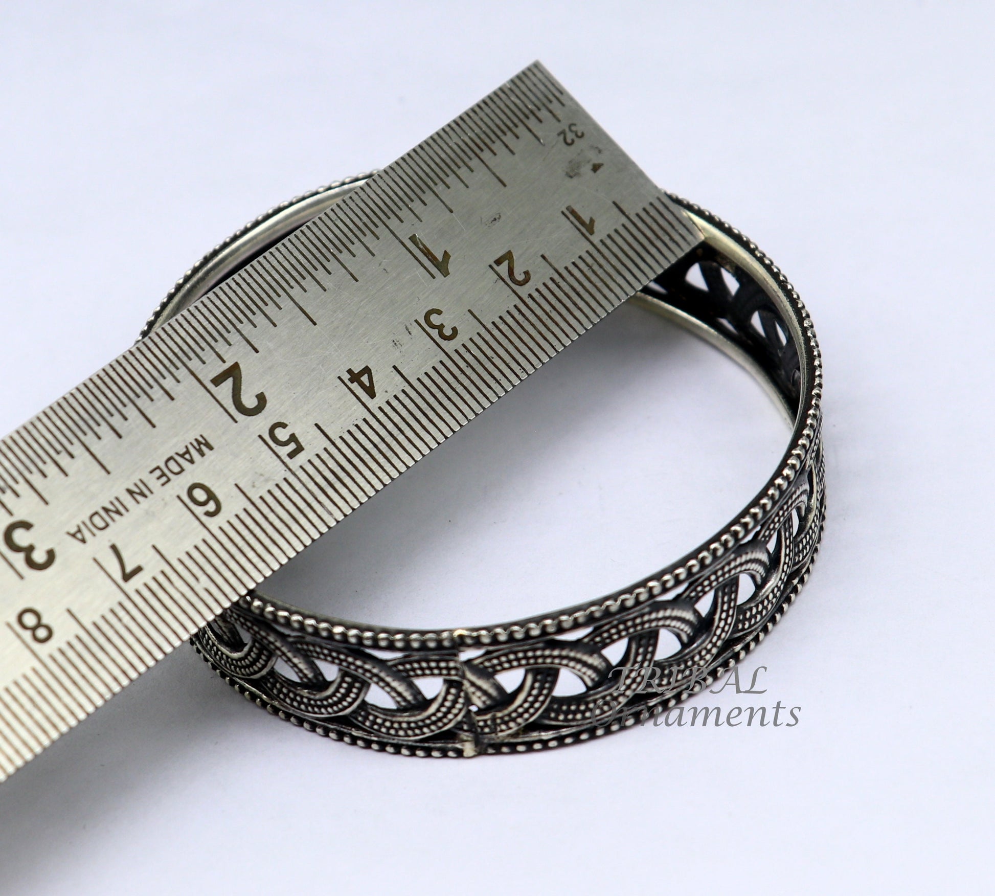 Sterling silver flower design bangle bracelet from TRIBAL ORNAMENTS' wedding jewelry collection, featuring intricate floral details.