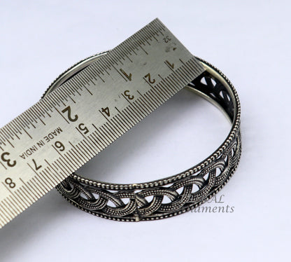 Sterling silver flower design bangle bracelet from TRIBAL ORNAMENTS' wedding jewelry collection, featuring intricate floral details.