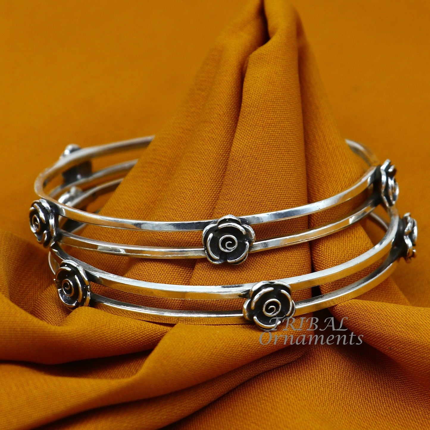 Sterling silver flower design bangle bracelet by TRIBAL ORNAMENTS, featuring intricate handmade floral jewelry for weddings.
