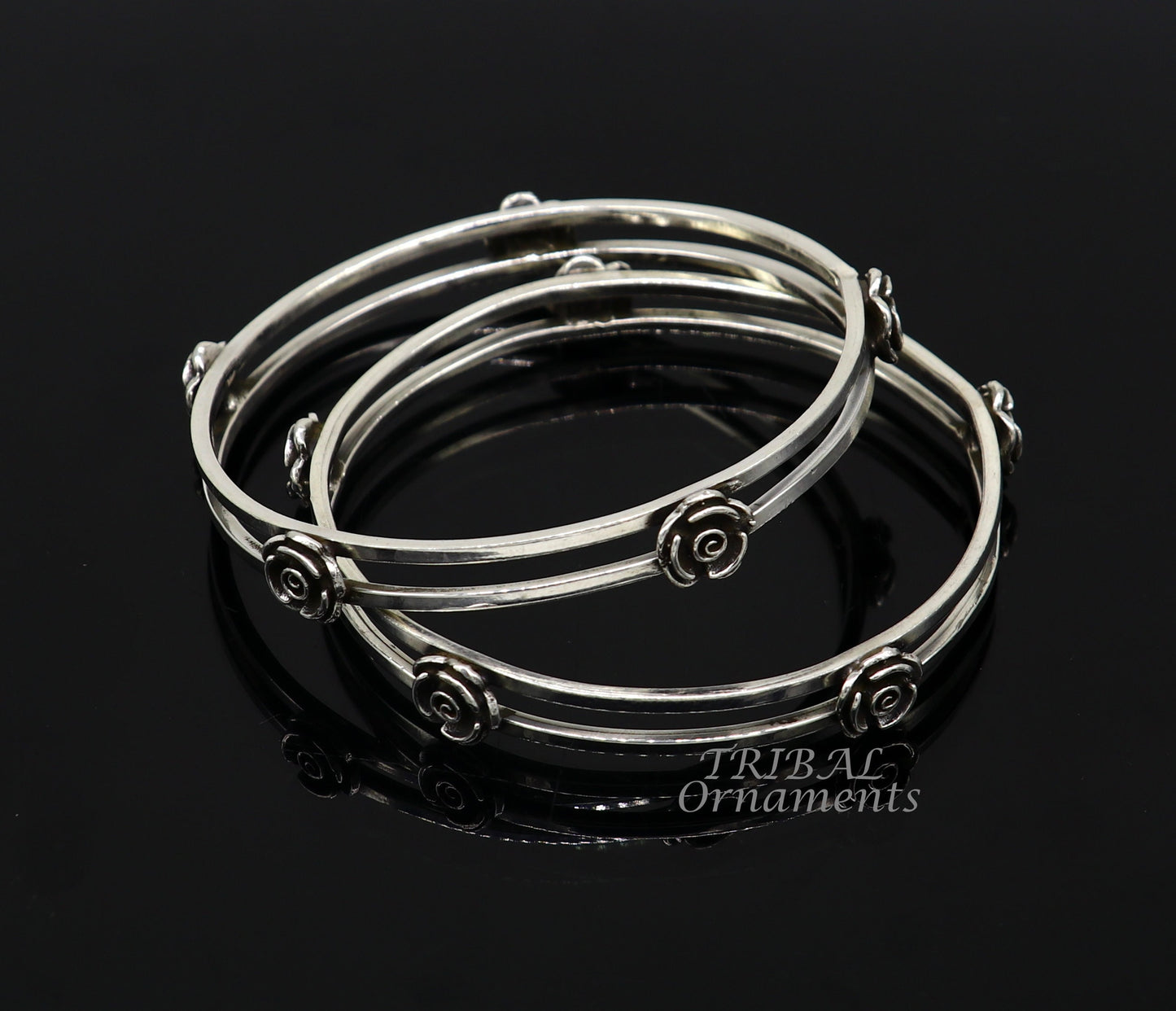 Sterling silver flower design bangle bracelet by Tribal Ornaments, featuring intricate handmade floral details for wedding jewelry.
