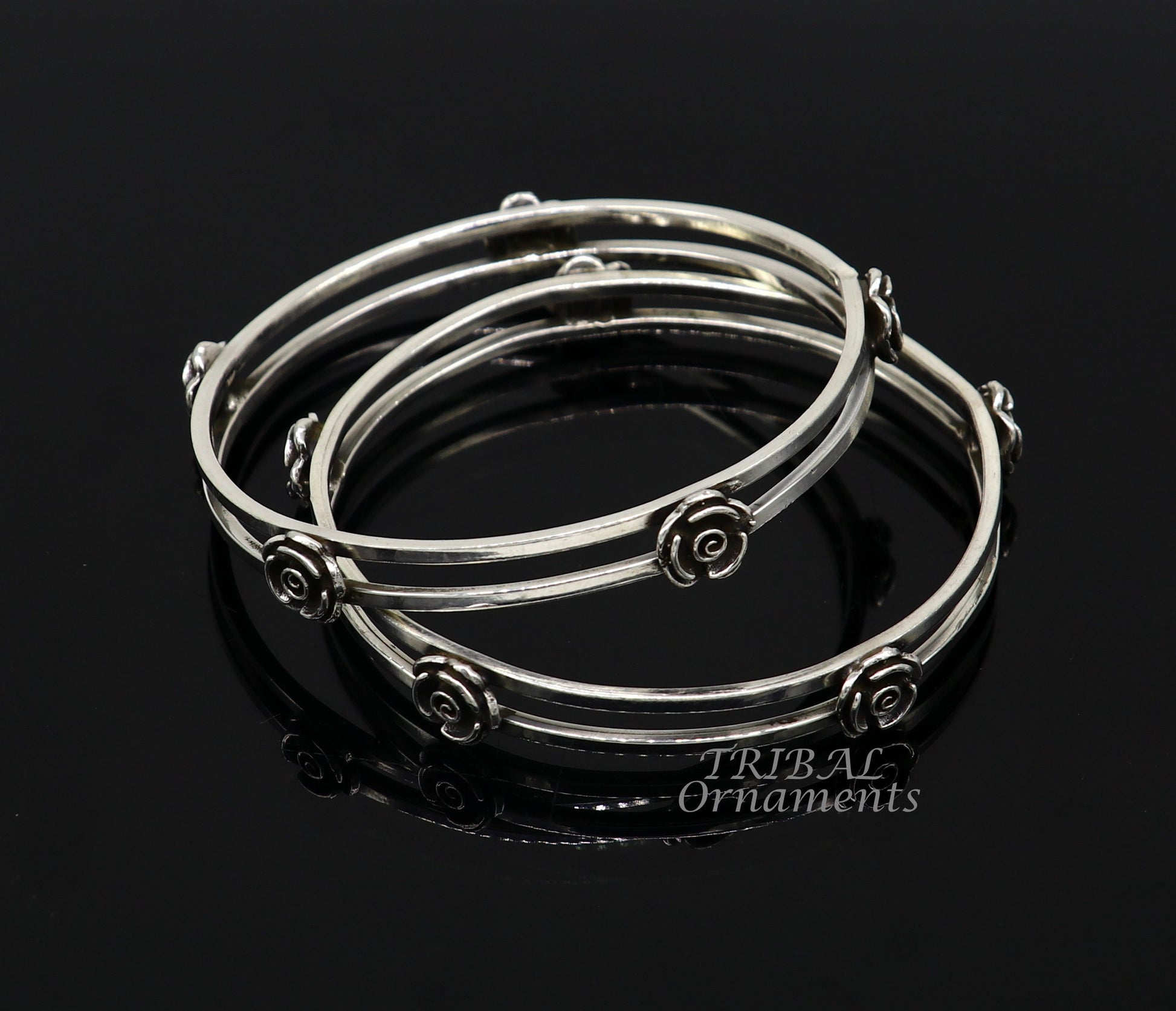 Sterling silver flower design bangle bracelet by Tribal Ornaments, featuring intricate handmade floral details for wedding jewelry.