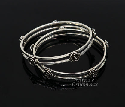 Sterling silver flower design bangle bracelet by Tribal Ornaments, featuring intricate handmade floral details for wedding jewelry.