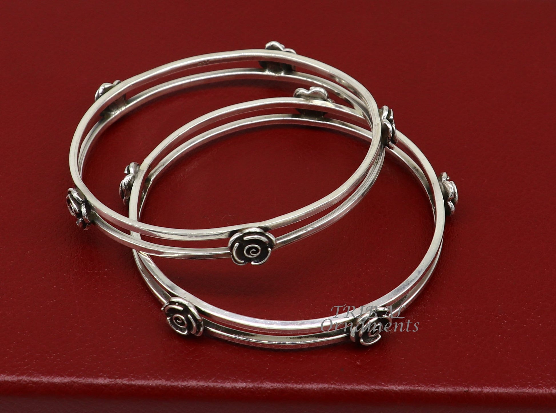 Sterling silver flower design bangle bracelet by TRIBAL ORNAMENTS, showcasing intricate handmade floral jewelry for brides and weddings.